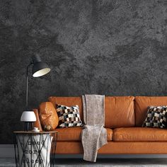 an orange leather couch with throw pillows on it