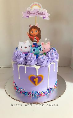 a birthday cake decorated with purple frosting and cartoon characters