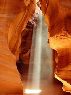 the light shines through an opening in antelope's canyon, arizona