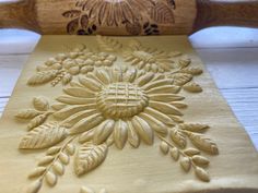 an intricately carved piece of wood sitting on top of a table