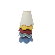 a lamp that is sitting on top of a white surface with different colors and shapes