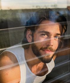 a man looking out the window at something