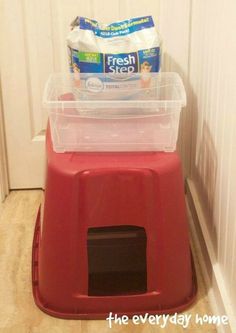 two plastic containers on top of a red trash can