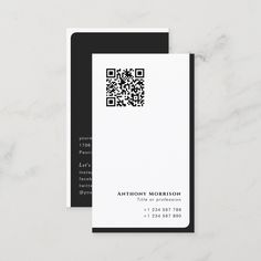 a white and black business card with a qr code on the front, next to it