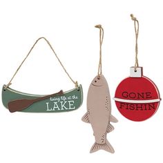 two christmas ornaments with one fish and one lake sign hanging from twine strings on each ornament