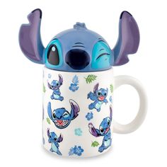 a ceramic mug with an image of stitch and stitch on the side, in front of a white background