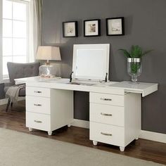 a white desk with two drawers and a mirror