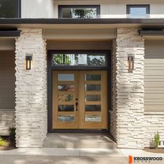 the front entrance to a house with two doors