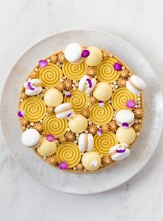 a white plate topped with a cake covered in lots of different types of candies