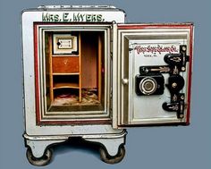 an old fashioned camera and cabinet are displayed