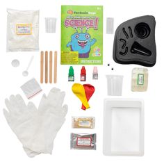 the contents of a science kit including gloves, glues, and other items to make an experiment