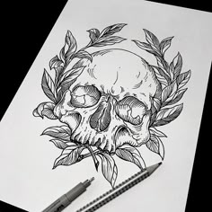 a drawing of a skull with leaves on it and a pencil in the foreground