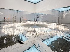 an artistic room with mirrored floors and lights