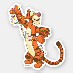 a sticker with a cartoon tiger on it's body and beads around its neck