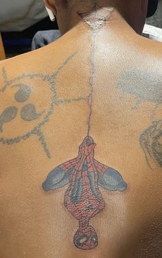 a man with a spiderman tattoo on his back