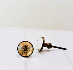 a close up of a glass knob with a bee on it's back end