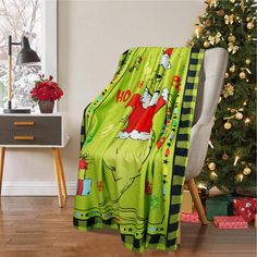 there is a green christmas blanket on the chair