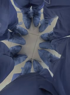 an overhead view of blue cloths with one person's feet in the middle