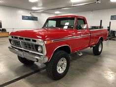 a red pickup truck parked in a garage