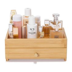 a wooden box filled with lots of different types of perfumes and lotion bottles