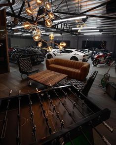 a living room filled with furniture and lots of lights hanging from it's ceiling