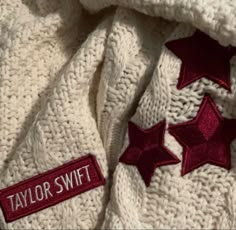 a white sweater with red stars on it