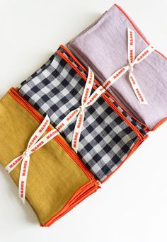 four pieces of cloth tied together on top of each other in different colors and patterns