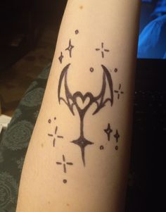 a tattoo on the arm of a person with a star and demon symbol drawn on it