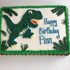 a birthday cake decorated with an image of a dinosaur