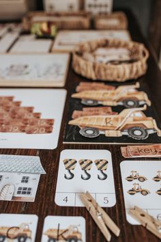 a table topped with lots of cards and wooden utensils