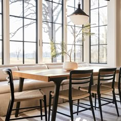 a living room filled with furniture and large windows