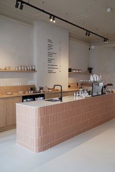 the counter in this restaurant is made of bricks and has many dishes on top of it