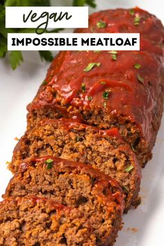 meatloaf with ketchup on top and the words vegan impossible meatloaf above it