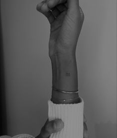 black and white photograph of a woman's hand holding onto her wrist