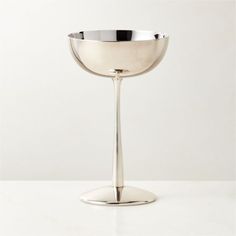 a silver goblet sitting on top of a white table