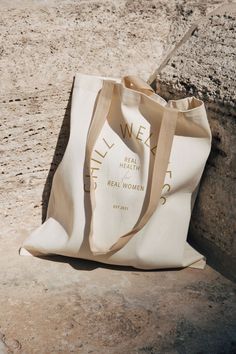 a white bag sitting on top of a rock