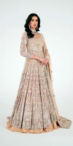 Pakistani Bridal Outfit in Wedding Lehenga Gown Style is a premium quality masterpiece that will give the gorgeous bride a head-turning trendy and traditional look on the wedding. Luxurious fabric makes this heavily embellished Pakistani Bridal Dress an epitome of beauty and grace. Pakistani Bridal Gown: Pakistani Bridal Gown in a beautiful pink color is intricately adorned with jaal work of shimmering silver details. This beautiful Pakistani Gown is beautifully adorned with shimmering embellishments. Resham, dabka, crystals, sequins, and pearls enhance the glamour of this Pakistani Bridal Outfit. Bridal Lehenga: Pakistani Bridal Gown is paired with a huge flared Lehenga. The Bridal Lehenga has a huge flare and it comes in an alluring pink shade. The fabric of this stunning Wedding Lehenga Bollywood Style Floor-length Anarkali Set For Ceremony, Elegant Semi-stitched Wedding Dress With Traditional Drape, Semi-stitched Wedding Dresses, Traditional Full-length Gown With Intricate Embroidery, Floor-length Wedding Dress For Ceremony, Elegant Floor-length Wedding Dress For Festive Season, Floor-length Choli With Dabka Work For Ceremony, Semi-stitched Floor-length Wedding Dress For Ceremony, Anarkali Floor-length Wedding Dress