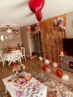 balloons and streamers fill the air in this living room decorated for valentine's day