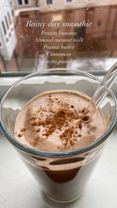 a glass bowl filled with chocolate pudding and topped with cinnamon