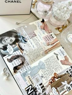 an open book with images of women in clothes and accessories on it, sitting on a table