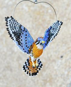 a beaded bird ornament hanging from a hook