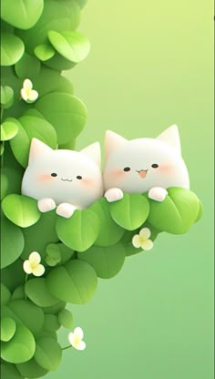 two white cats sitting on top of green leaves next to each other with flowers in the background