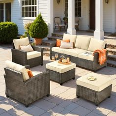 an outdoor living area with wicker furniture