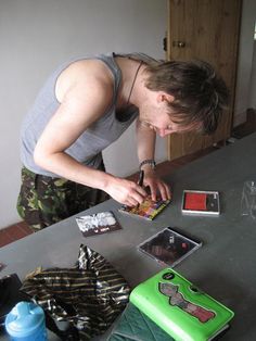 a young man is looking at pictures on the table