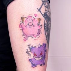 a woman's leg with tattoos on her legs and an image of two cats