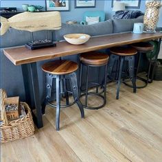 a living room filled with lots of furniture and pictures on the wall next to a bar