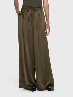 A 100% silk high rise, wide-leg trouser with front center pleats for a dramatic silhouette that drapes beautifully. Featuring a skinny waist tie for an adjustable fit and side and back pockets. High Rise FitDry Clean Only100% Silk13.25" Front Rise/32" Inseam/28.5" Leg Opening Military Style Green Wide Leg Bottoms, Green Silk Wide-leg Pants, Green Military Bottoms With Belt Loops, Silk Wide-leg Bottoms With Pockets, Military Trousers With Belt Loops, Silk Trousers, Menswear Inspired, Military Green, Guinea Bissau