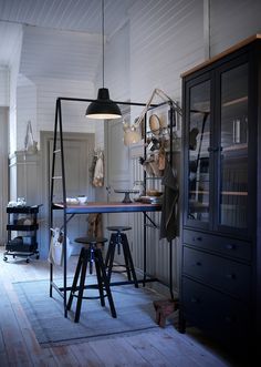 a room that has some lights hanging from the ceiling and various items on the table