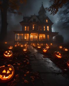 halloween pumpkins lit up in front of a large house at night with lights on