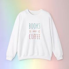 a white sweatshirt that says books and coffee on the front, against a multicolored background